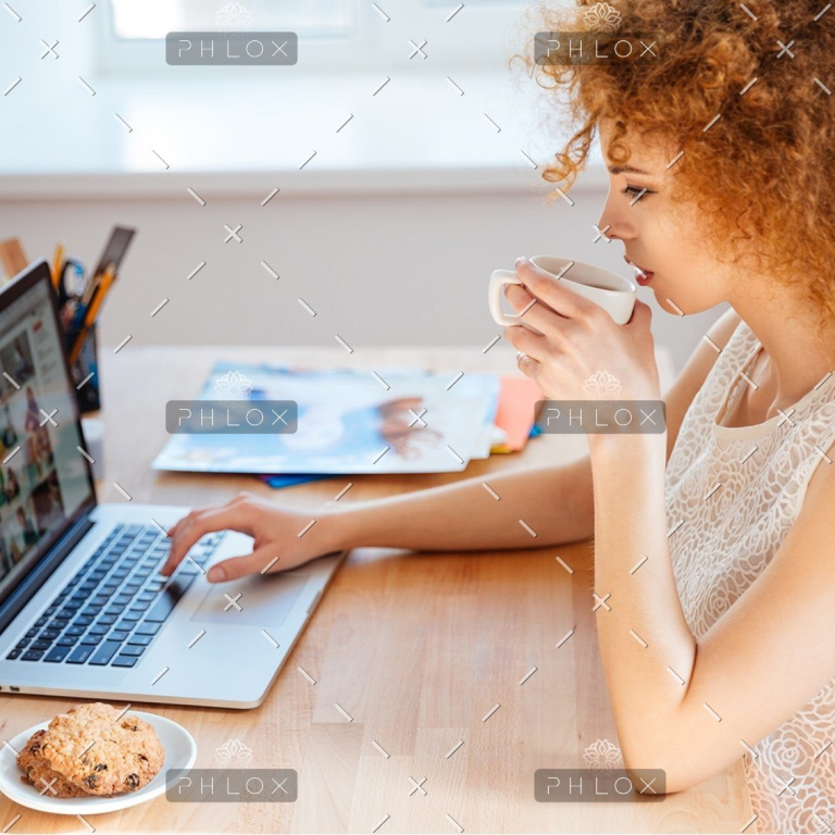 demo-attachment-218-woman-photographer-drinking-coffee-and-working-PJNBP6U@2x