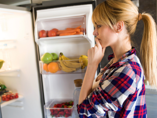 Woman choosing a refrigerator option
