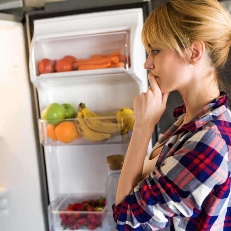 Woman choosing a refrigerator option