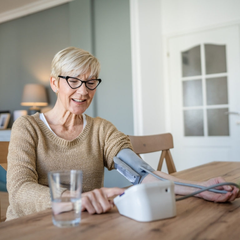 elderly woman taking blood pressure