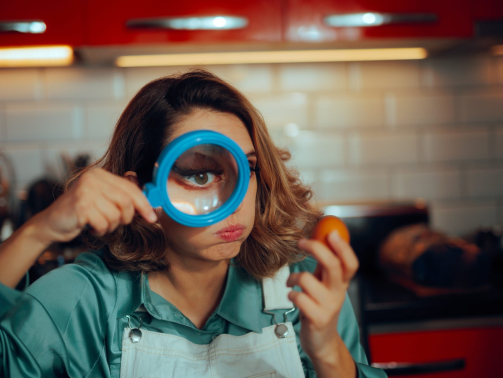 woman with magnifying glass and egg