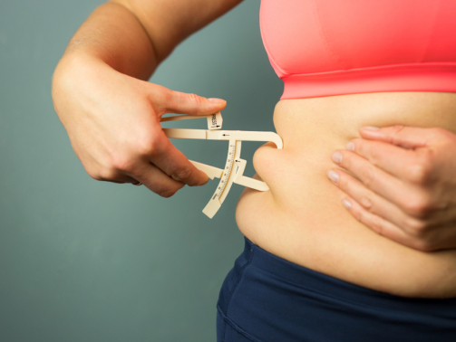 woman with body fat calculator